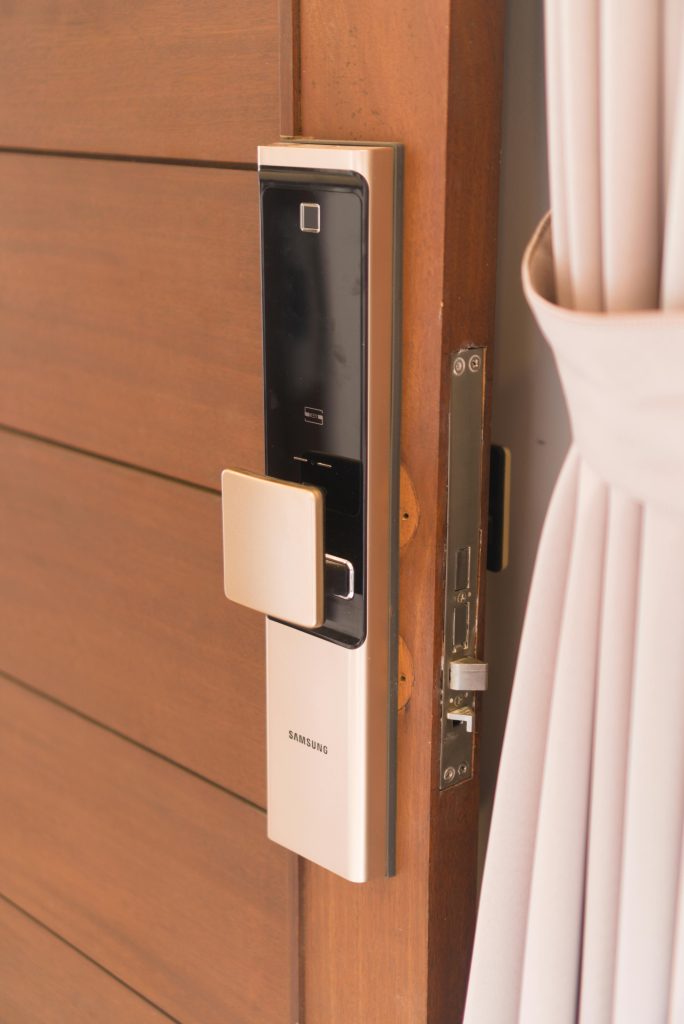 Close-up of a smart door lock system, offering enhanced security on a wooden door.